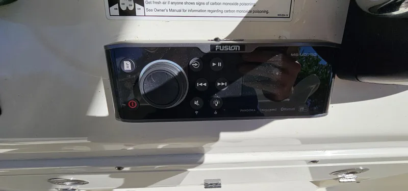 Slide: The Image of Fusion marine audio system on 2017 Cobia 277 Center Console boat dashboard. - 27