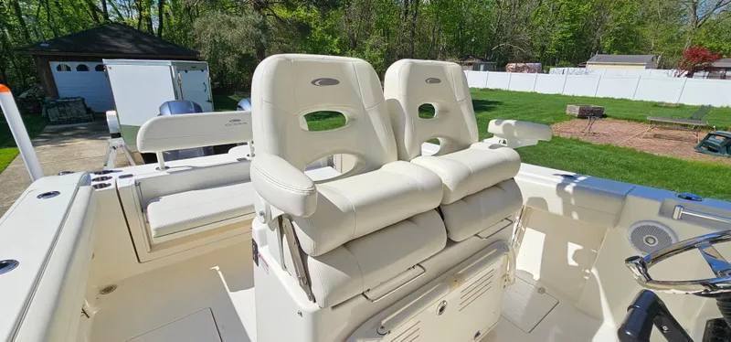 Slide: The Image of 2017 Cobia 277 Center Console boat with dual white cushioned seats. - 29