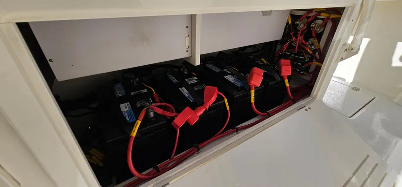 Slide: The Image of Battery compartment of a 2017 Cobia 277 Center Console boat with red cables. - 31