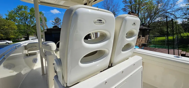 Slide: The Image of 2017 Cobia 277 Center Console boat seats under clear blue sky. - 35