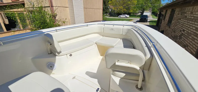 Slide: The Image of 2017 Cobia 277 Center Console boat interior with white seating and railings. - 39