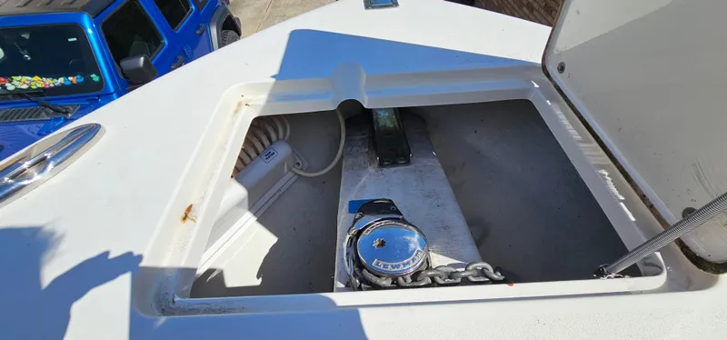 Slide: The Image of 2017 Cobia 277 Center Console anchor compartment with winch and chain. - 40