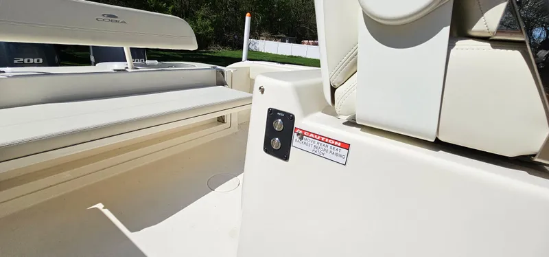 Slide: The Image of 2017 Cobia 277 Center Console boat interior, featuring seating and control panel. - 49