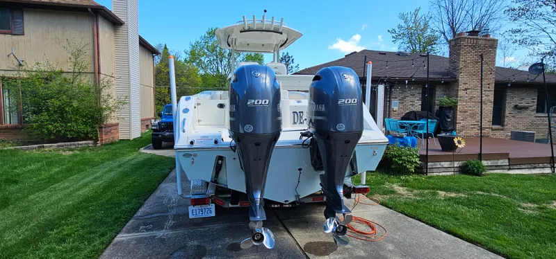 Slide: The Image of 2017 Cobia 277 Center Console boat with dual Yamaha 200 engines parked in driveway. - 7