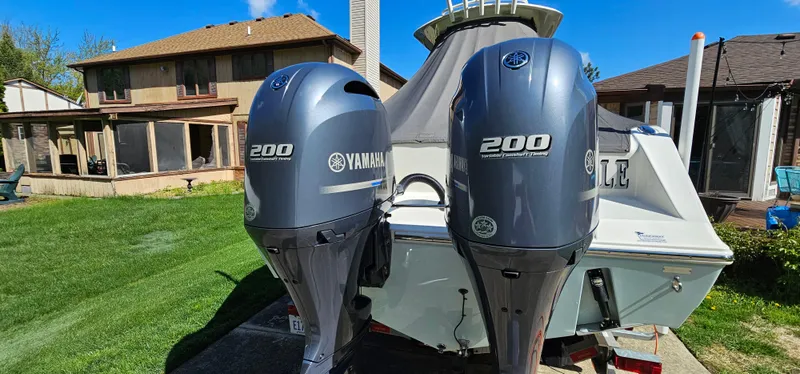 Slide: The Image of 2017 Cobia 277 Center Console with twin Yamaha 200 engines in a residential backyard. - 9