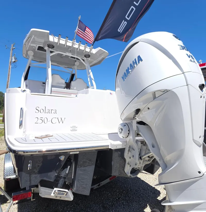 Slide: The Image of 2025 Solara S-250 CW boat with Yamaha engine, displayed outdoors under clear blue sky. - 10