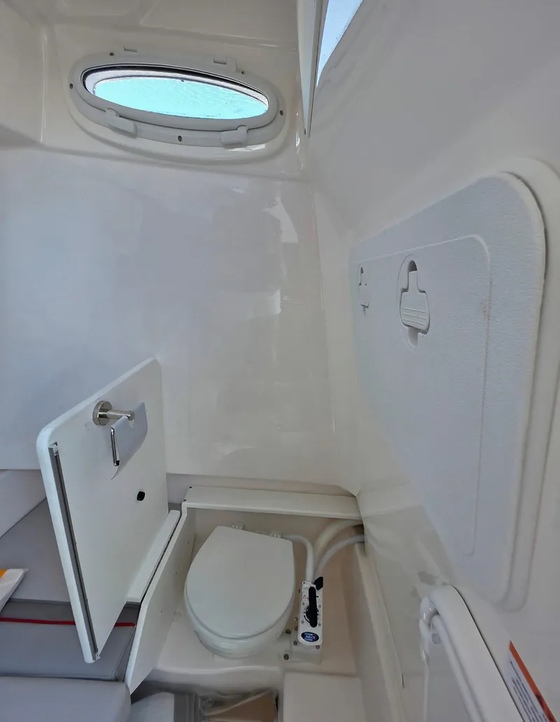 Slide: The Image of 2025 Solara S-250 CW boat interior with compact marine toilet and storage compartment. - 6