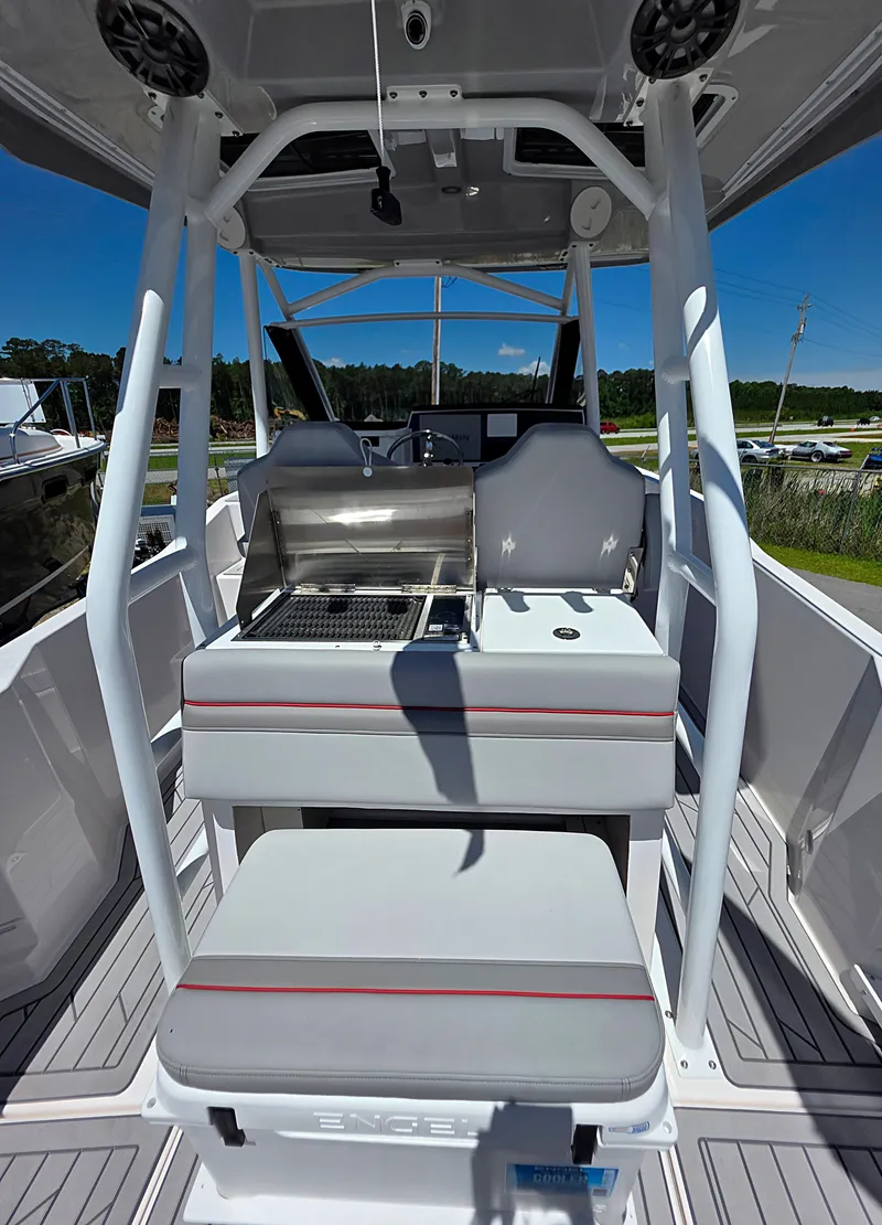 Slide: The Image of 2025 Solara S-250 CW boat interior with seating and grill under clear blue sky. - 7