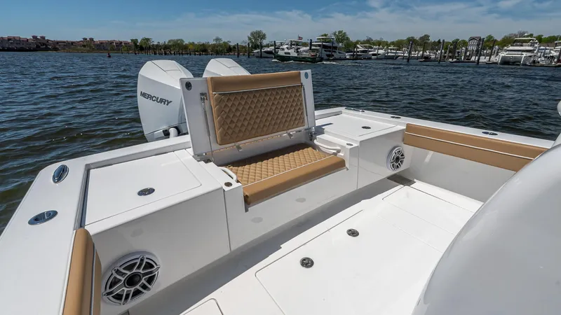 Slide: The Image of 2025 Valhalla Boatworks V-29 Hybrid with tan seating, on a calm water backdrop. - 10