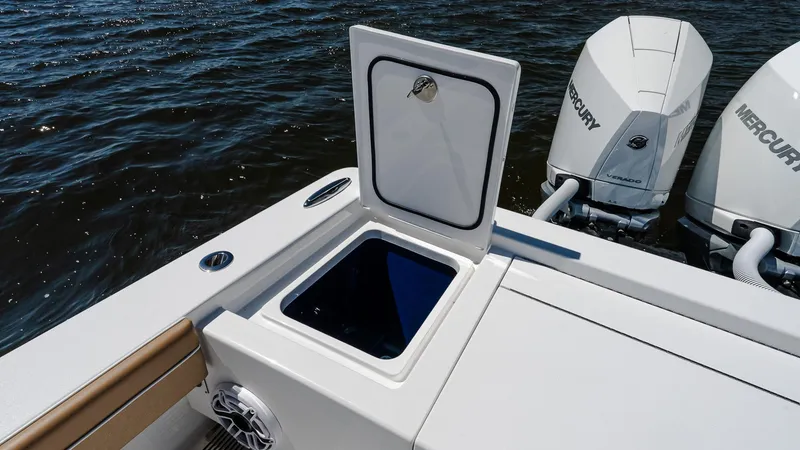 Slide: The Image of 2025 Valhalla V-29 Hybrid boat with open storage compartment and dual Mercury engines. - 12