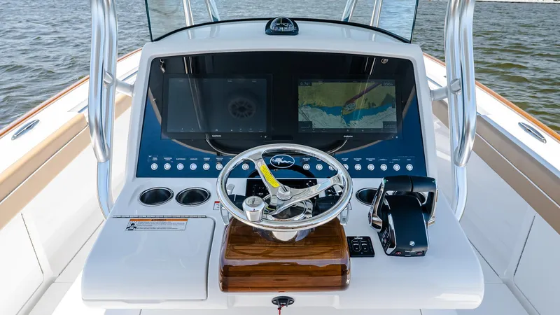 Slide: The Image of 2025 Valhalla V-29 Hybrid boat dashboard with steering wheel and navigation screens. - 24