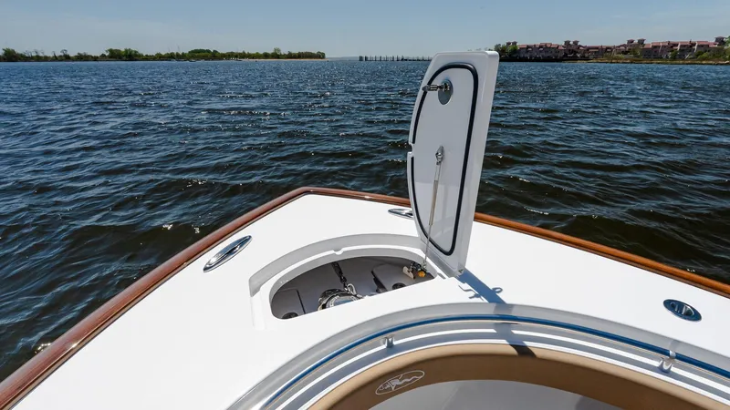 Slide: The Image of 2025 Valhalla Boatworks V-29 Hybrid on water, open hatch, scenic view. - 25