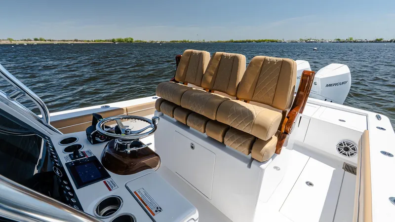 Slide: The Image of 2025 Valhalla Boatworks V-29 Hybrid, luxurious seating, modern helm, on calm water. - 26
