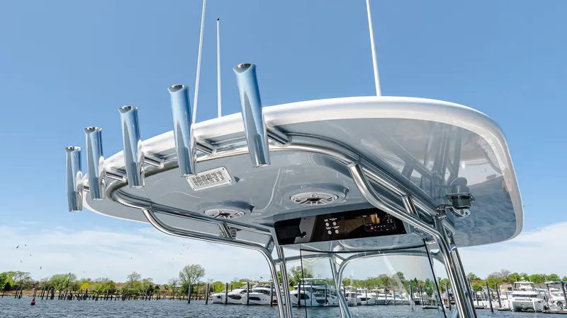 Slide: The Image of 2025 Valhalla Boatworks V-29 Hybrid T-top with rod holders on a sunny day. - 28