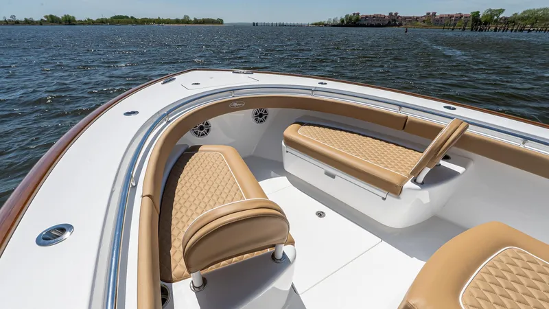 Slide: The Image of 2025 Valhalla Boatworks V-29 Hybrid with tan seating, cruising on a calm lake. - 36