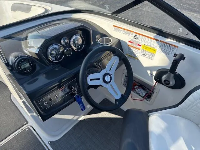 Slide: The Image of 2021 Bayliner VR5 Bowrider I/O dashboard with steering wheel and control panel. - 10