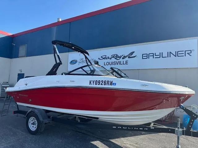 Slide: The Image of 2021 Bayliner VR5 Bowrider I/O boat in red, parked on a trailer at a dealership. - 3