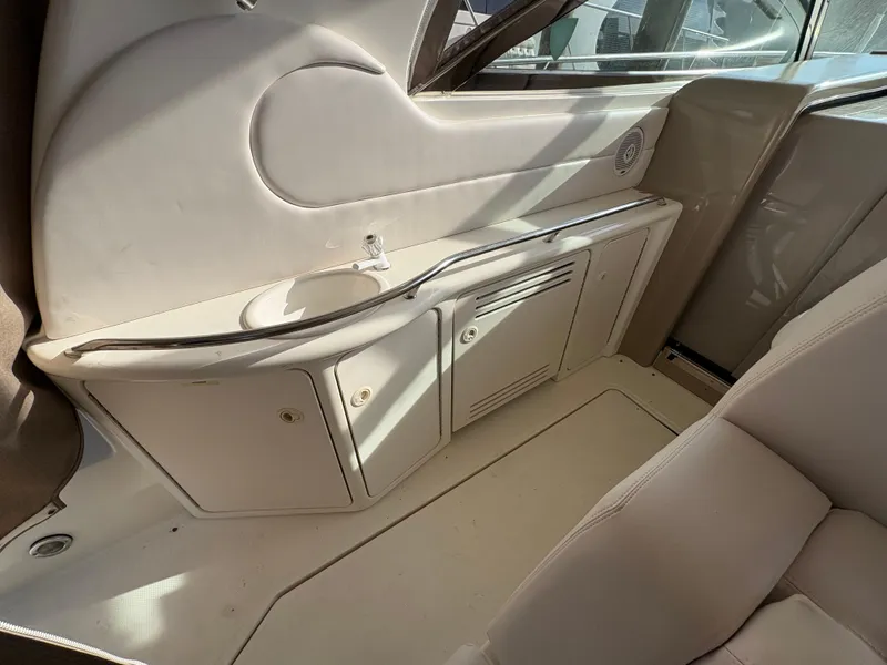 Slide: The Image of Interior of 1999 Sea Ray 410 Express Cruiser with storage cabinets and sink. - 12