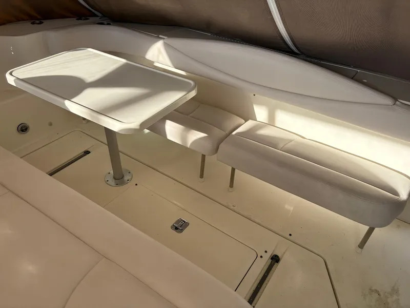 Slide: The Image of 1999 Sea Ray 410 Express Cruiser interior with seating and table. - 13