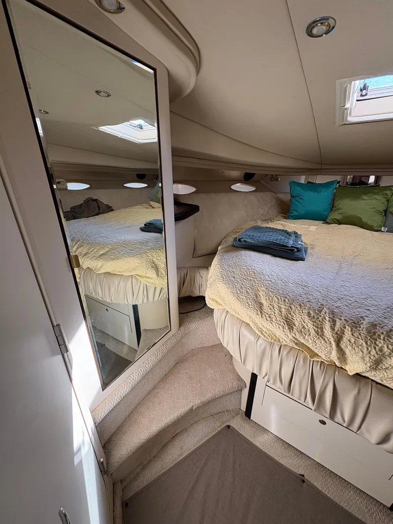 Slide: The Image of 1999 Sea Ray 410 Express Cruiser cabin with bed, mirror, and skylight. - 6