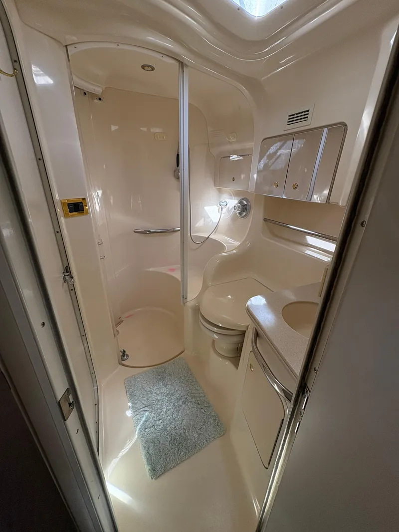Slide: The Image of 1999 Sea Ray 410 Express Cruiser bathroom with shower, sink, and toilet. - 7