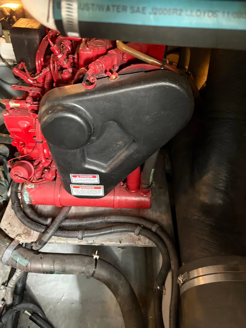 Slide: The Image of Engine compartment of a 1999 Sea Ray 410 Express Cruiser with visible red engine components. - 8