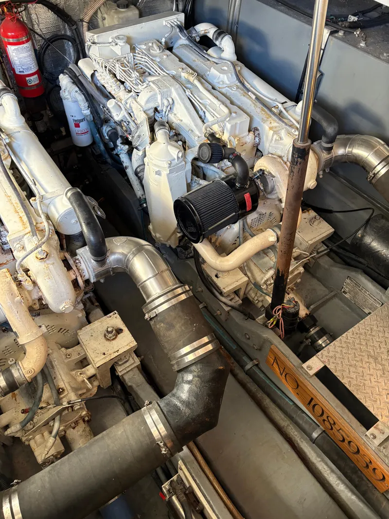 Slide: The Image of Engine room of a 1999 Sea Ray 410 Express Cruiser with visible components and fire extinguisher. - 9