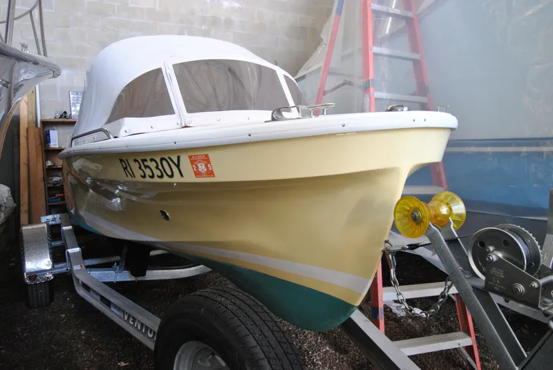 Slide: The Image of 2023 Dyer Glamour Girl boat on water, person steering, American flag displayed. - 1