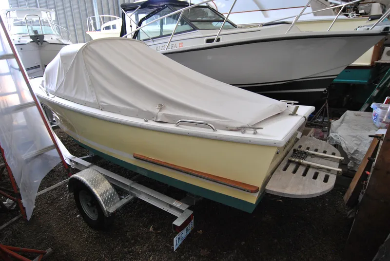 Slide: The Image of 2023 Dyer Glamour Girl boat on water, person in orange jacket, American flag displayed. - 4