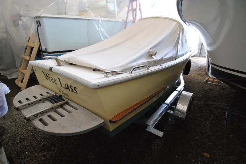 Slide: The Image of A 2023 Dyer Glamour Girl boat with an American flag on the water. - 5