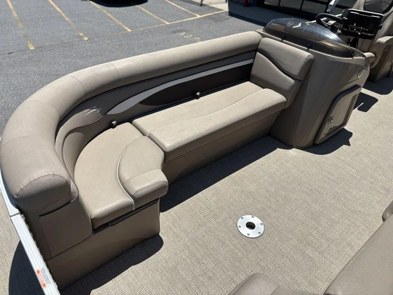Slide: The Image of 2019 Bennington 23 SSRCX pontoon boat with beige seating and carpeted deck. - 10