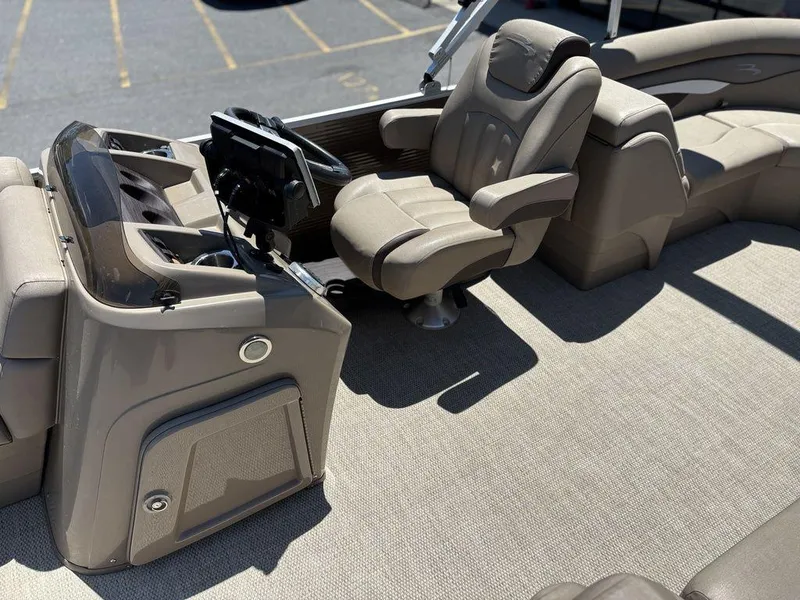 Slide: The Image of 2019 Bennington 23 SSRCX boat interior with captain's chair and control panel. - 12
