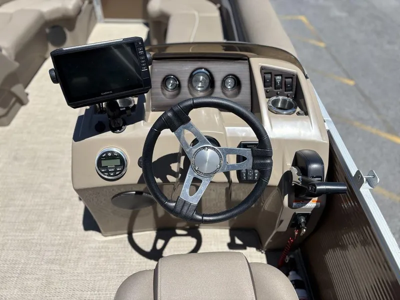 Slide: The Image of 2019 Bennington 23 SSRCX boat dashboard with steering wheel and navigation system. - 16