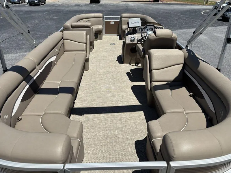 Slide: The Image of 2019 Bennington 23 SSRCX pontoon boat with spacious beige seating and modern helm. - 18