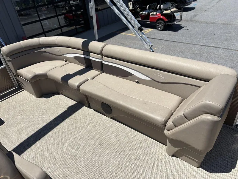 Slide: The Image of 2019 Bennington 23 SSRCX pontoon boat with beige seating and spacious deck area. - 19