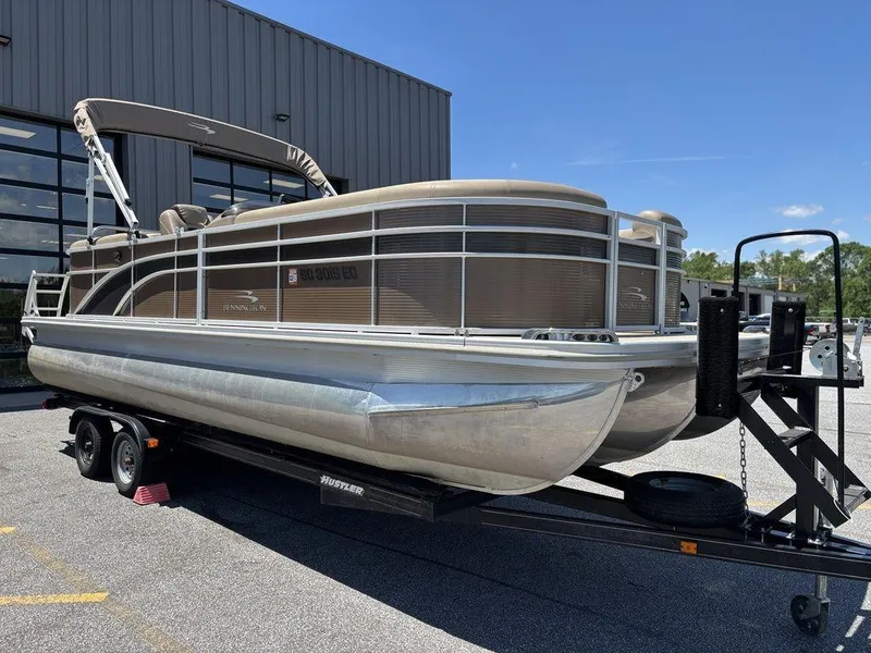 Slide: The Image of 2019 Bennington 23 SSRCX pontoon boat on trailer, parked outdoors. - 8