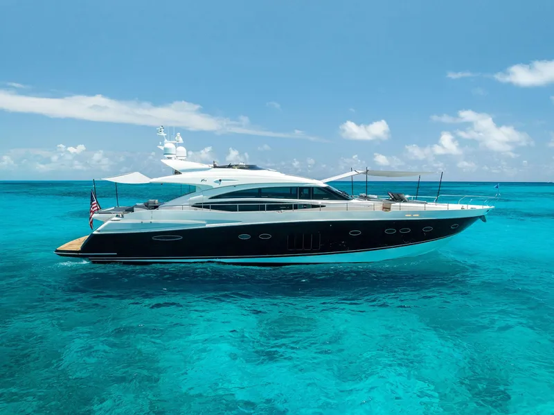 Slide: The Image of Luxurious 2009 Princess Motor Yacht cruising on clear turquoise waters under a bright blue sky. - 11