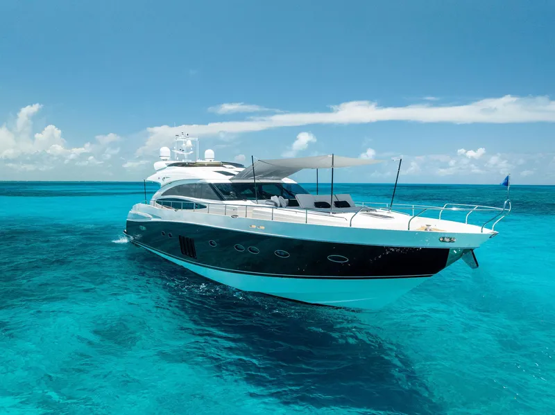 Slide: The Image of Luxurious 2009 Princess Motor Yacht cruising on clear turquoise waters under a bright blue sky. - 12