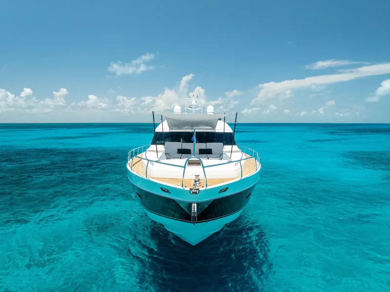 Slide: The Image of Luxurious 2009 Princess Motor Yacht on clear turquoise waters under a bright blue sky. - 13
