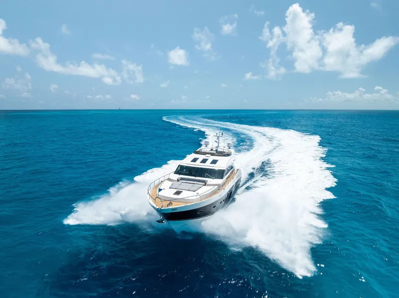 Slide: The Image of Luxurious 2009 Princess motor yacht cruising on clear blue ocean under a sunny sky. - 2