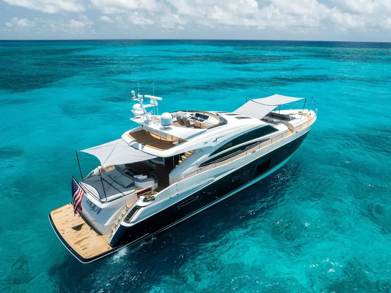 Slide: The Image of Luxurious 2009 Princess Motor Yacht cruising on clear turquoise waters under a sunny sky. - 23
