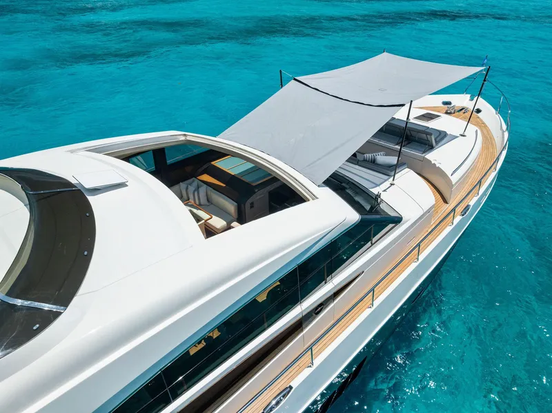 Slide: The Image of Luxurious 2009 Princess Motor Yacht on clear blue water, featuring sleek design and sunshade. - 25