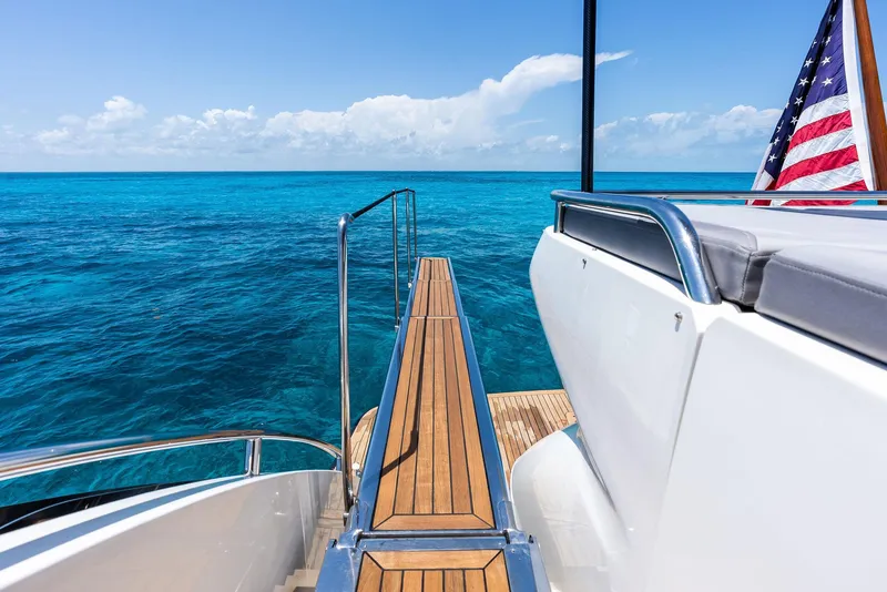 Slide: The Image of 2009 Princess Motor Yacht with wooden deck, ocean view, and American flag. - 33