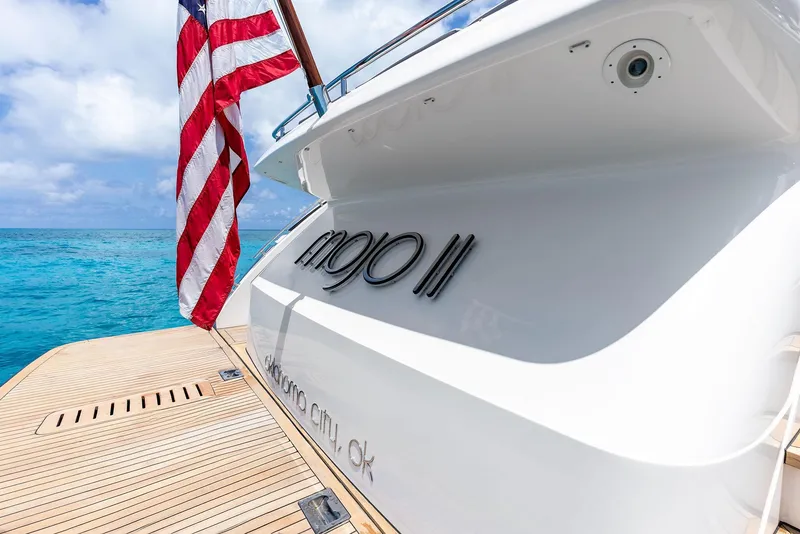 Slide: The Image of 2009 Princess Motor Yacht with American flag, docked on clear blue water. - 35