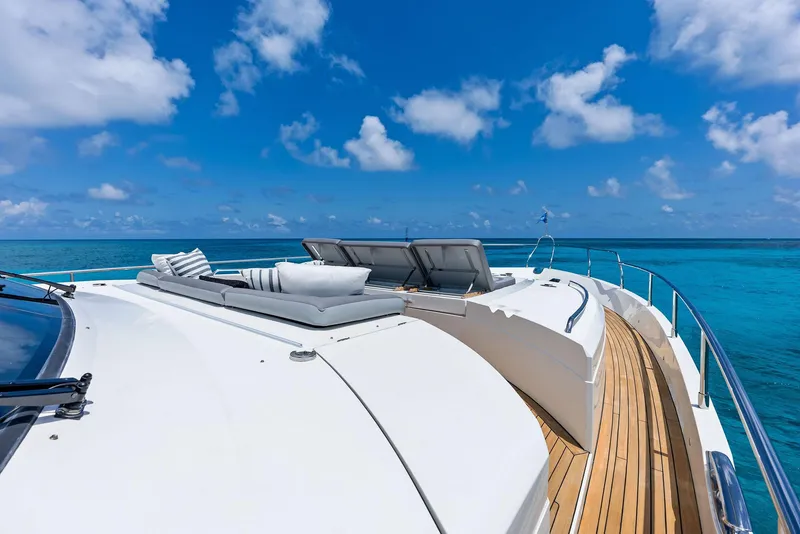 Slide: The Image of Luxurious 2009 Princess Motor Yacht deck with sun loungers, ocean view, and clear blue sky. - 46