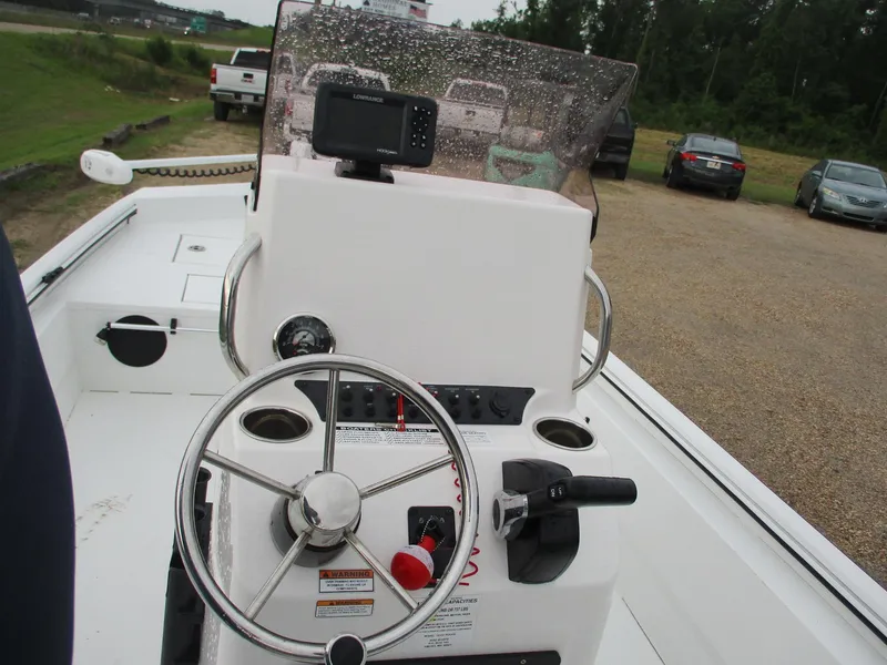 Slide: The Image of 2023 Avid 18 Rogue CC boat console with steering wheel and controls. - 10
