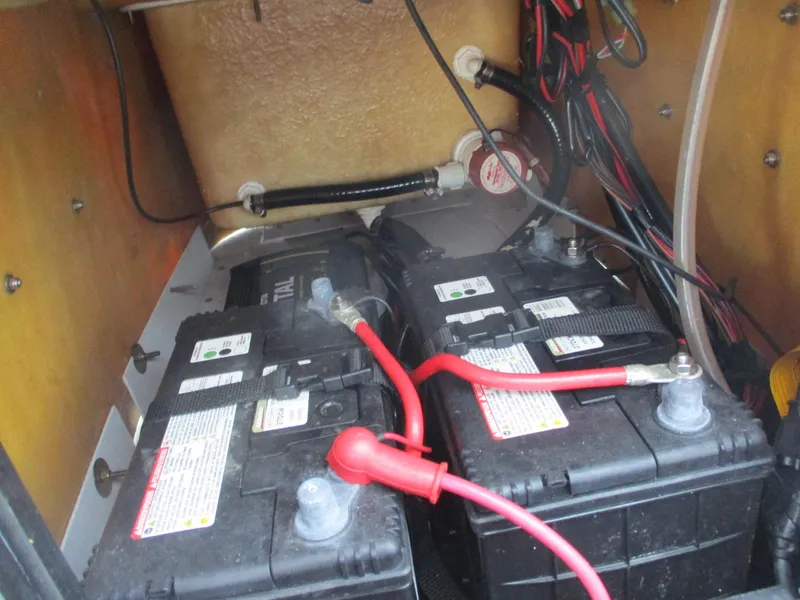 Slide: The Image of Batteries and wiring inside a 2023 Avid 18 Rogue CC boat compartment. - 11