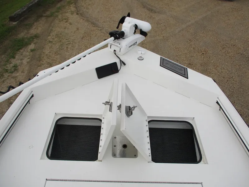 Slide: The Image of 2023 Avid 18 Rogue CC boat deck with open storage compartments. - 5