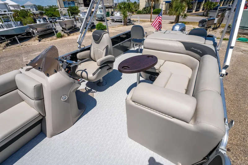 Slide: The Image of 2021 South Bay 224FCR pontoon boat with beige seating and a small table. - 13