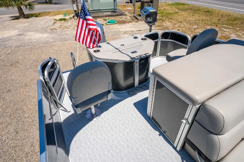 Slide: The Image of 2021 South Bay 224FCR pontoon boat with seating, table, and American flag. - 15
